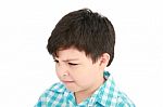 Small Boy In Frowning Mood Stock Photo