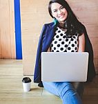 Smart Asian Businesswoman Using A Laptop On The Cafe Floor Stock Photo