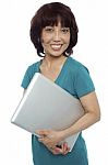 Smiling Asian Woman Carrying Laptop Stock Photo