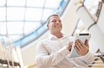 Smiling Businessman With Tablet Computer In Modern Business Buil Stock Photo