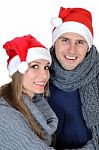 Smiling Couple In Santa Claus Hats Stock Photo