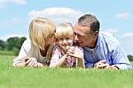 Smiling Couple With Daughter Posing At Outdoors Stock Photo
