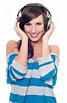 Smiling Female Listening Music Stock Photo