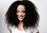 Smiling Female Model With Curly Hair Stock Photo