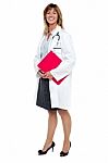 Smiling Female Physician Holding Clipboard Stock Photo