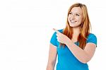 Smiling Lady Looking And Pointing Away Stock Photo