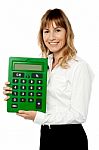 Smiling Lady Showing Big Green Calculator Stock Photo