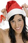 Smiling Woman Holding Santa Hat Stock Photo