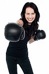 Smiling Young Female Boxer Ready To Punch You Stock Photo