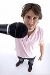 Standing Man Showing Microphone Stock Photo