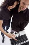 Standing Young Couple Looking Into Laptop Stock Photo