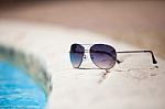 Sunglasses Over Swimming Pool Stock Photo