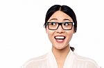 Surprised Young Girl In Eyeglasses Looking Away Stock Photo