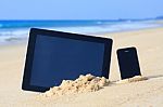 Tablet And Smartphone On The Beach Stock Photo