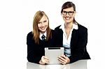 Teacher And Student Holding Tablet Device Together Stock Photo