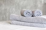 Towels On Bed And Stucco Wall Stock Photo