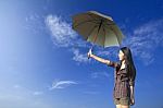 Umbrella And Woman In Blue Sky Stock Photo