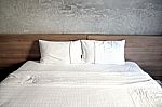 White Bed With A Pillow Or Two Stock Photo