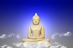 White Buddha Seated On Sky Stock Photo