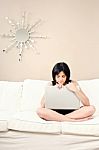 Woman And Laptop On Sofa Stock Photo