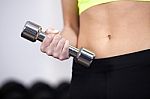 Woman At The Gym Lifting Free Weights Stock Photo