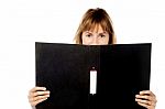 Woman Hiding Face With Business File Stock Photo
