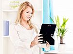 Woman Holding Frame Of Photo At Home Stock Photo
