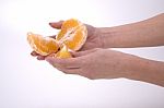 Woman Holding Slices Of Orange Stock Photo