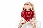 Woman Holds A Heart Shape To Her Face Stock Photo