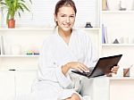 Woman In Bathrobe With Computer Stock Photo