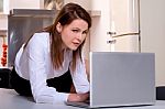 Woman In Kitchen With Laptop