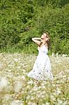 Woman looking up In Meadow Stock Photo
