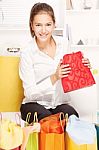 Woman On Sofa With Shopping Bags Stock Photo