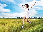 Woman Running Across Field Stock Photo