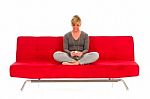 Woman Sat On Red Sofa  Stock Photo