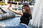 Woman Sitting  And Making Selfie Stock Photo
