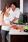 Woman Sliceing Tomatoes With Her Boyfriend Stock Photo