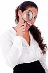 Woman Smiling With Magnifying Lens Stock Photo