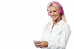 Woman With Headphones And Cell Phone Stock Photo