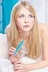 Woman With Nail File In Bedroom Stock Photo