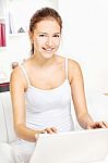 Woman Working On Laptop At Home Stock Photo