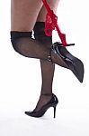 Woman's Legs With Fishnet Stockings And Red Slip Stock Photo