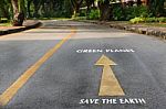 Words Of Save The Earth And Green Planet On The Road Surface Stock Photo