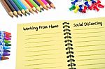 Working From Home And Social Distancing Texts On Notebook stock photo