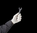 Working Hand In Glove Holding Wrench Stock Photo