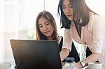 Young Asian Women Workers Working Together In Office Stock Photo