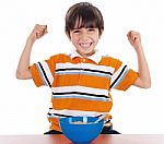 Young Boy Shows His Strength By Raising His Arms Stock Photo
