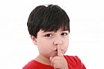 Young Boy Shows Silence Symbol Stock Photo
