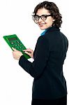 Young Businesswoman Using Calculator Stock Photo