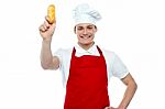 Young Chef Holding Bread Roll Stock Photo